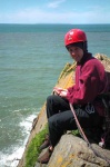 Hilary belaying at Baggy; Lundy behind