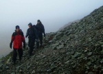 Tom, Jack and David traverse the screes below Pikes Crag