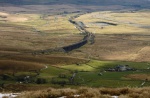Looking down at Ribblehead as a train crosses the viaduct