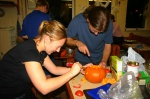 Lisette and Robin carve pumpkins
