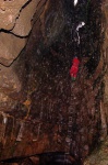 Cath descending into the spray-filled cavern